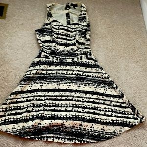 tan and black dress with cut out back.